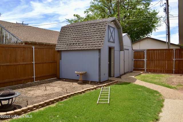 200 Crescent Dr, Littlefield, TX 79339 - view of yard with a fenced backyard, an outdoor fire pit, an outdoor structure, and a storage unit