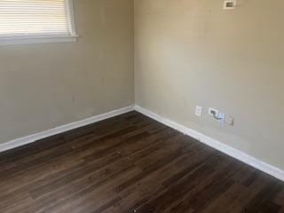 spare room featuring dark hardwood / wood-style floors