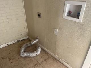 laundry area with tile patterned floors and hookup for an electric dryer