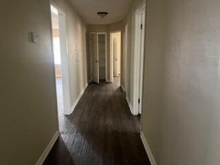 corridor featuring dark wood-type flooring