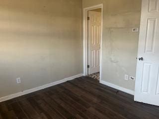 empty room featuring dark hardwood / wood-style flooring