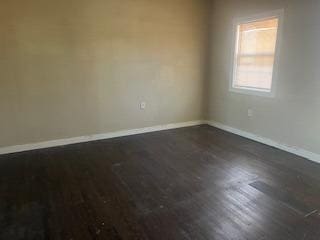 unfurnished room featuring dark hardwood / wood-style flooring