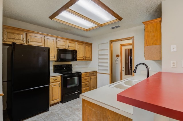 kitchen featuring light tile patterned floors, sink, a textured ceiling, and black appliances