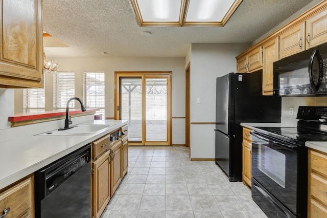 kitchen featuring sink, black appliances, a textured ceiling, and light tile patterned flooring