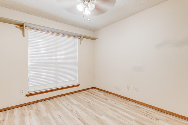 spare room featuring ceiling fan, a textured ceiling, and light hardwood / wood-style floors