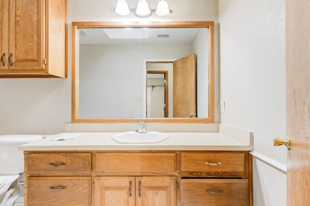 bathroom featuring vanity and toilet