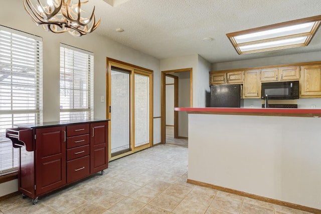 kitchen with pendant lighting, light tile patterned floors, a notable chandelier, black appliances, and a textured ceiling