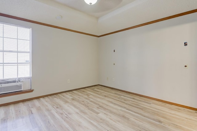 unfurnished room with cooling unit, crown molding, and light hardwood / wood-style floors