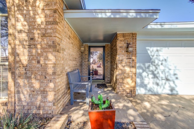 view of exterior entry with a garage