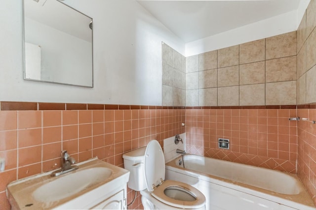 full bathroom featuring tile walls, vanity, bathing tub / shower combination, and toilet