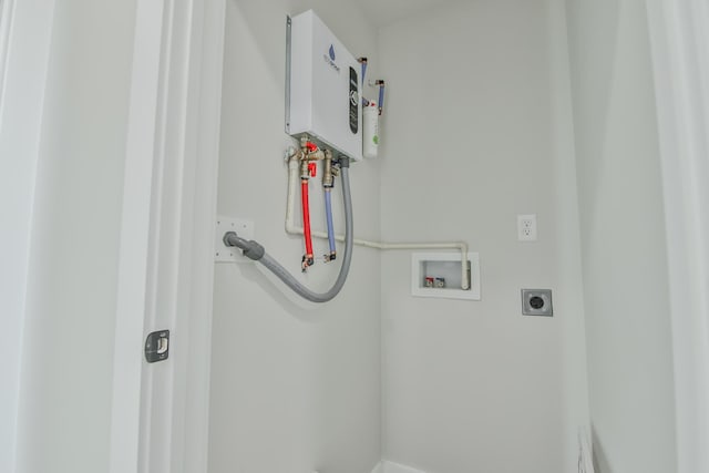 laundry room with electric dryer hookup, hookup for a washing machine, water heater, and laundry area