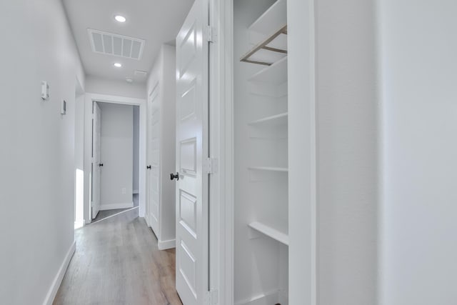corridor featuring recessed lighting, light wood finished floors, visible vents, and baseboards