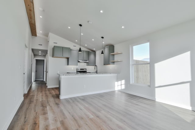 kitchen featuring a sink, under cabinet range hood, gray cabinets, open shelves, and light wood-type flooring