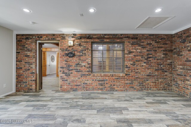 3413 42nd St, Lubbock, TX 79413 - unfurnished room featuring wood finished floors, brick wall, baseboards, and recessed lighting