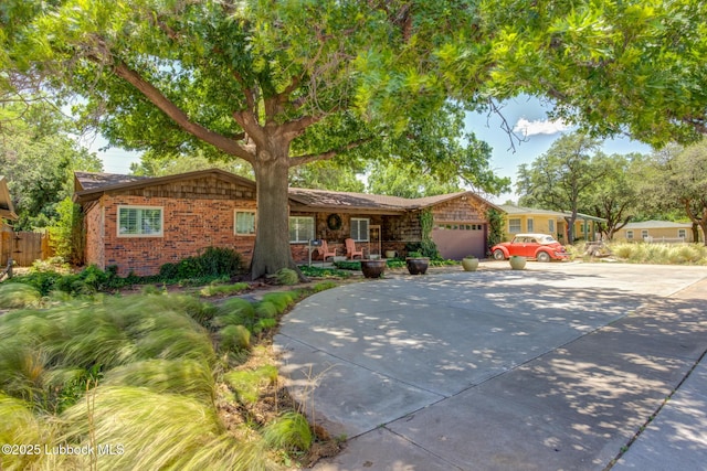 3413 42nd St, Lubbock, TX 79413 - single story home with an attached garage, concrete driveway, and brick siding