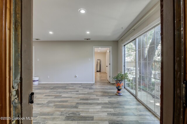 3413 42nd St, Lubbock, TX 79413 - unfurnished room featuring light wood-style floors, baseboards, and recessed lighting