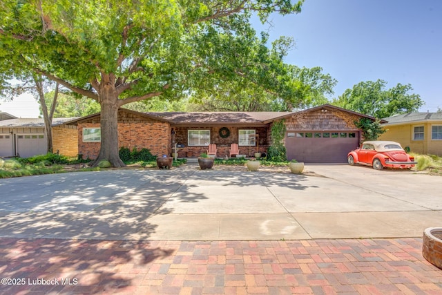 3413 42nd St, Lubbock, TX 79413 - view of front facade with concrete driveway and an attached garage
