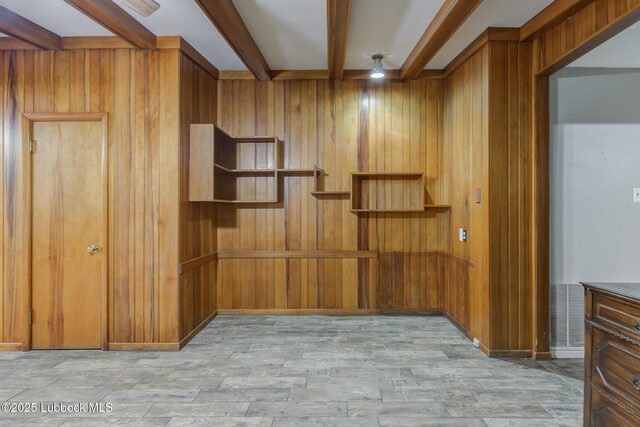3413 42nd St, Lubbock, TX 79413 - empty room featuring beam ceiling, wooden walls, a ceiling fan, and wood finished floors