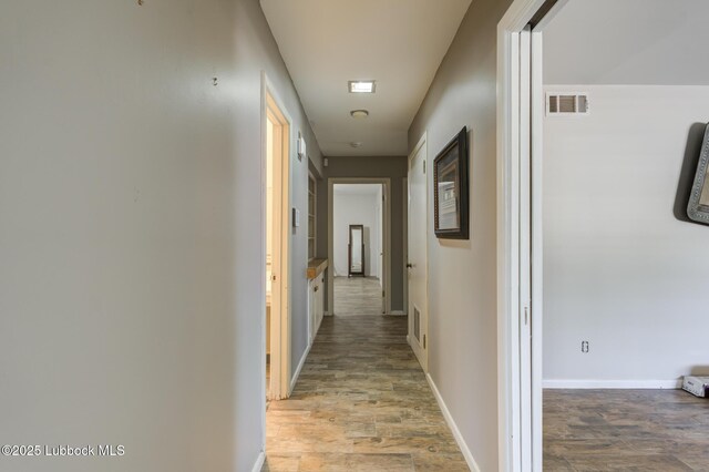3413 42nd St, Lubbock, TX 79413 - corridor featuring wood finished floors and baseboards