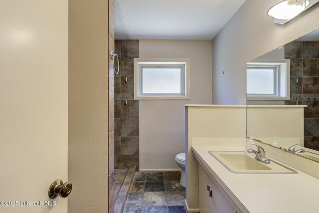 3413 42nd St, Lubbock, TX 79413 - full bath with toilet, tiled shower, vanity, and stone finish flooring