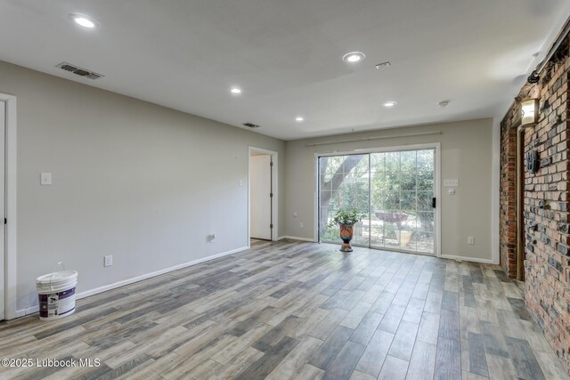 3413 42nd St, Lubbock, TX 79413 - unfurnished room with wood finished floors, baseboards, and recessed lighting
