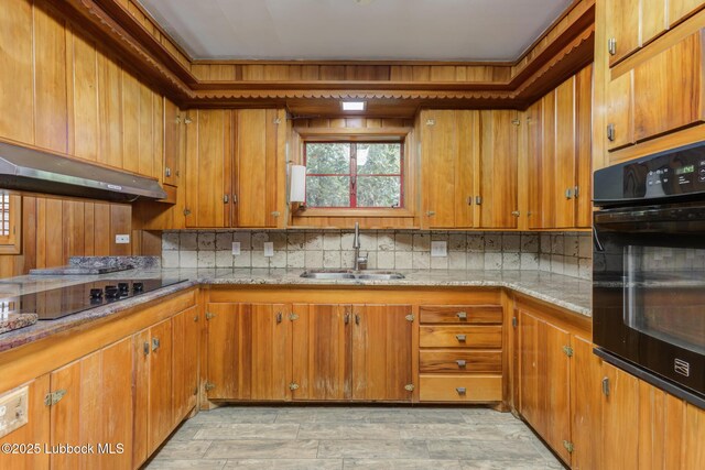3413 42nd St, Lubbock, TX 79413 - kitchen with a sink, black appliances, and brown cabinetry