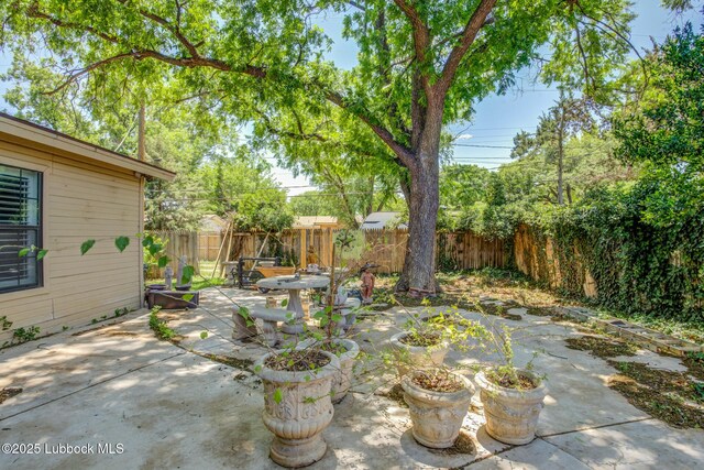 3413 42nd St, Lubbock, TX 79413 - fenced backyard with a patio