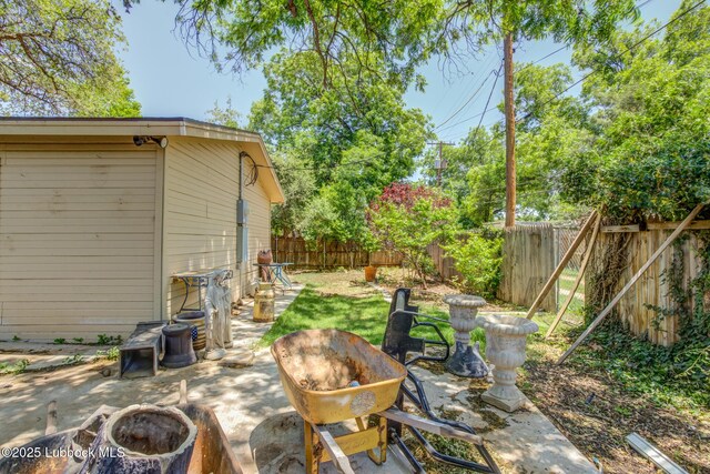 3413 42nd St, Lubbock, TX 79413 - fenced backyard with a patio area and a fire pit