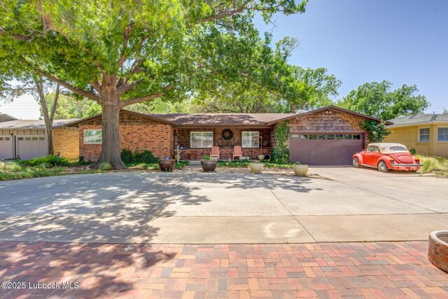 3413 42nd St, Lubbock, TX 79413 - view of front facade with concrete driveway and an attached garage