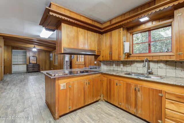 3413 42nd St, Lubbock, TX 79413 - kitchen featuring a sink, brown cabinets, a peninsula, and black electric stovetop