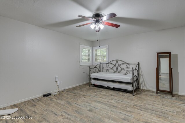 3413 42nd St, Lubbock, TX 79413 - bedroom with wood finished floors, baseboards, and a ceiling fan