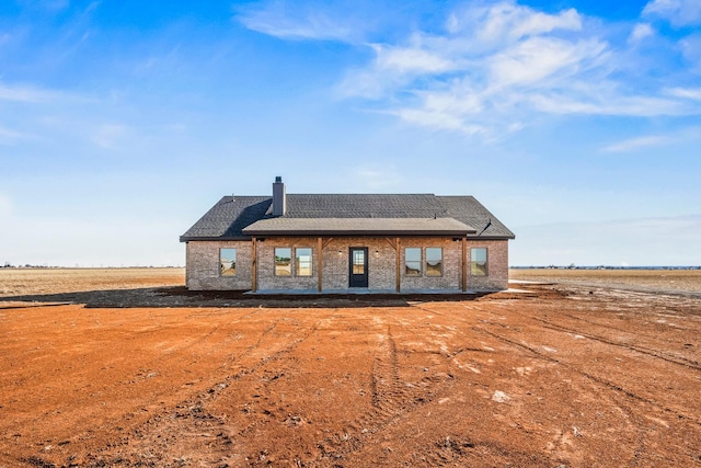 back of property featuring a rural view