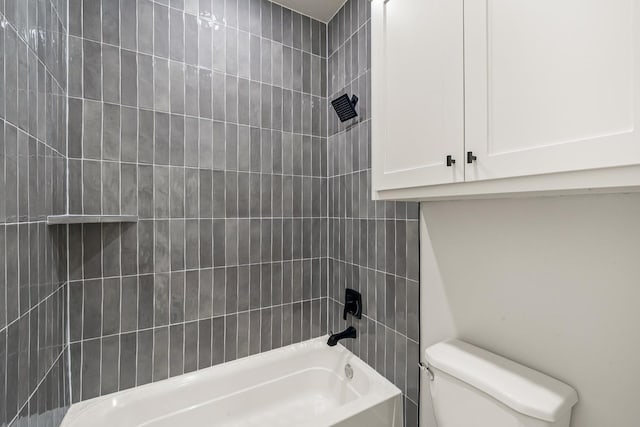 bathroom with tiled shower / bath combo and toilet