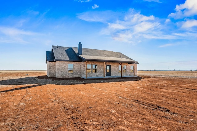 back of house with a rural view