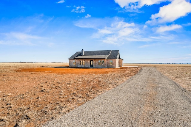 ranch-style house featuring a rural view