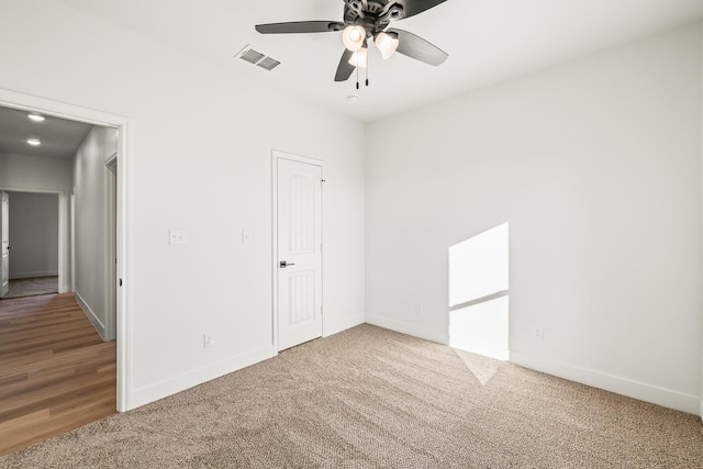 empty room with ceiling fan and carpet