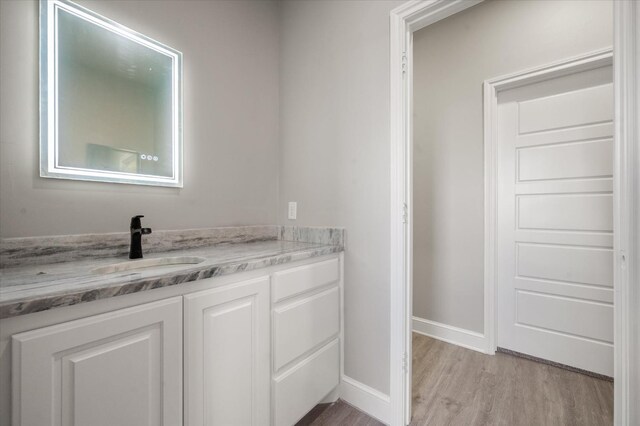 bathroom with vanity and hardwood / wood-style floors