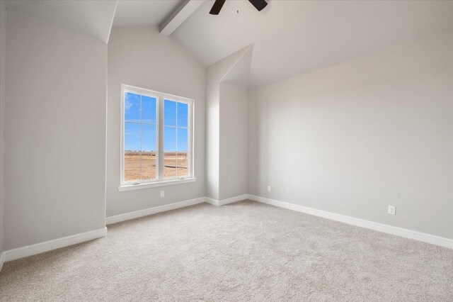 empty room featuring ceiling fan, carpet floors, and lofted ceiling with beams