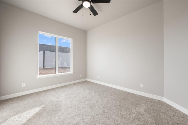 unfurnished room with ceiling fan and carpet flooring