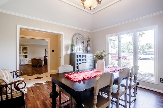 dining room with crown molding and dark wood-type flooring