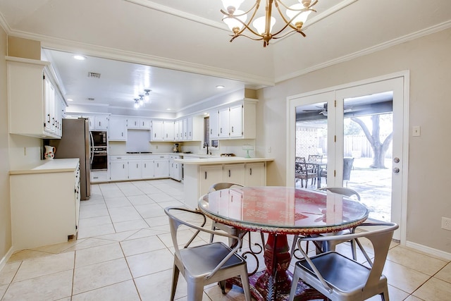 dining area featuring light tile patterned flooring, ornamental molding, and an inviting chandelier