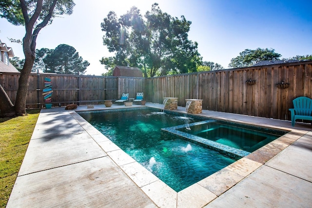 view of pool with pool water feature, an in ground hot tub, and a patio area