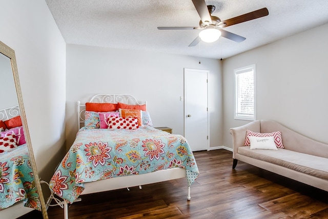 bedroom with ceiling fan, dark hardwood / wood-style floors, and a textured ceiling