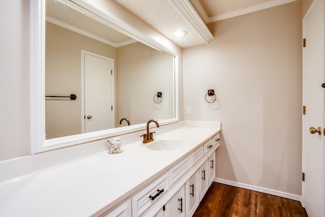 bathroom featuring vanity, hardwood / wood-style floors, and ornamental molding