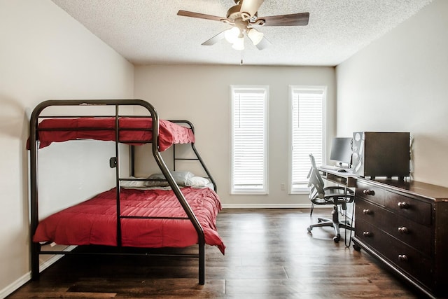 bedroom with ceiling fan, dark hardwood / wood-style floors, and a textured ceiling