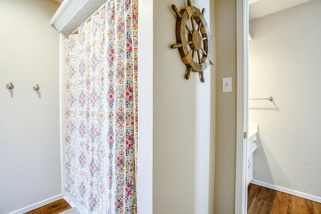 bathroom with hardwood / wood-style floors