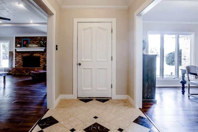 foyer with crown molding, hardwood / wood-style floors, and a fireplace