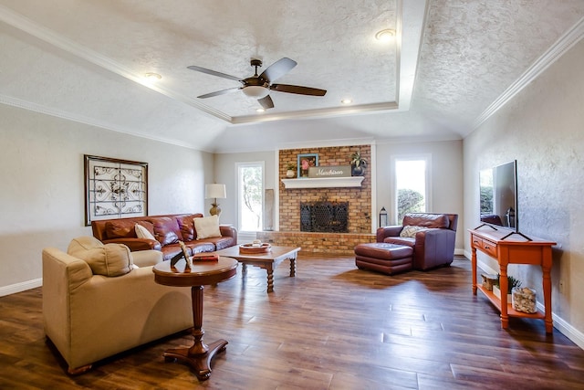 living room with plenty of natural light, dark hardwood / wood-style flooring, a tray ceiling, and a textured ceiling