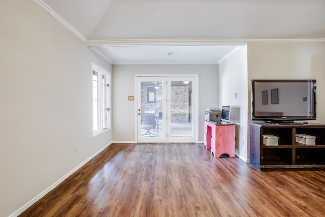 living room with hardwood / wood-style floors and crown molding