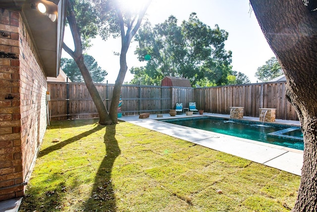 view of swimming pool featuring pool water feature and a yard